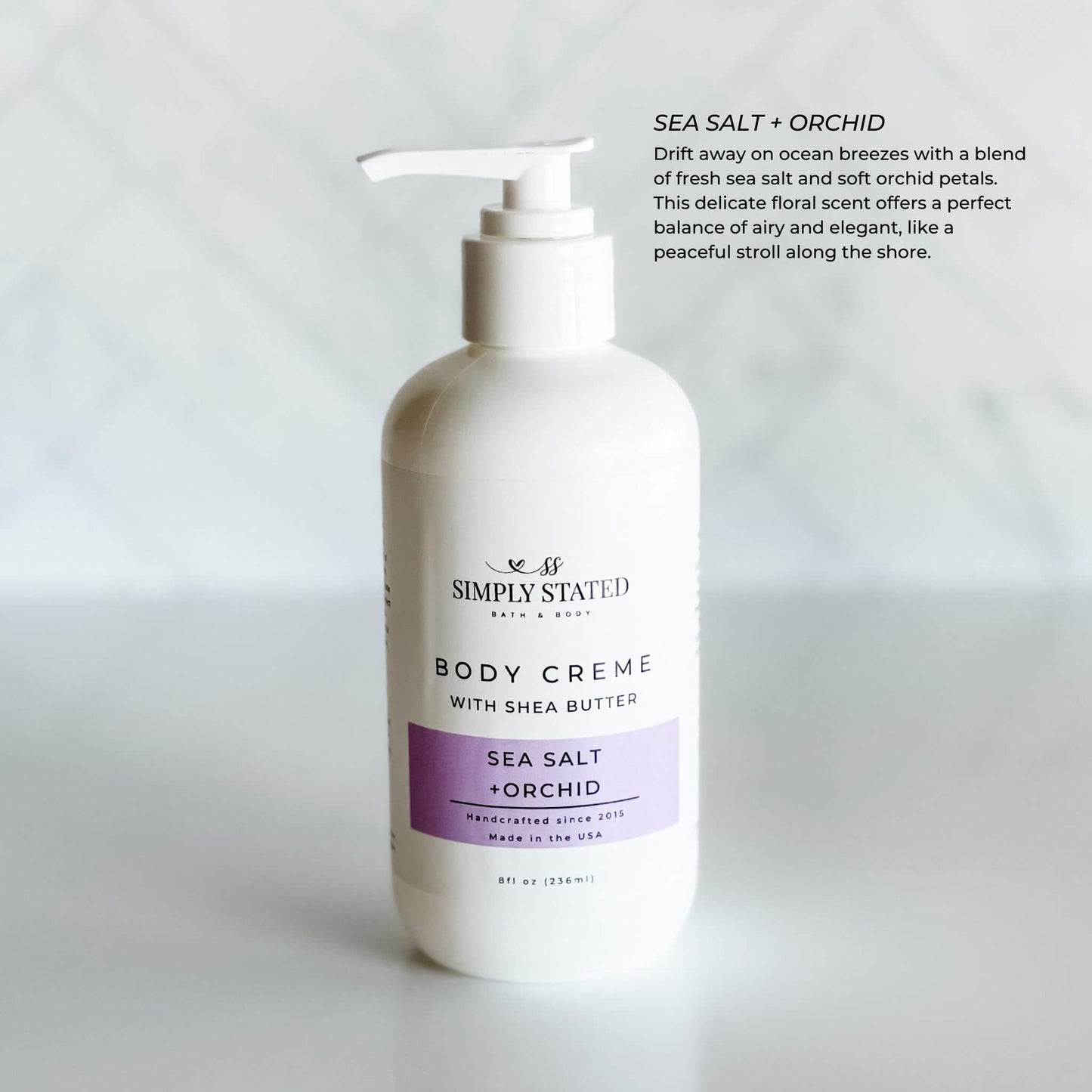 8oz pump bottle of Simply Stated Bath & Body Sea Salt + Orchid Body Creme with shea butter, combining ocean breeze and floral scents.
